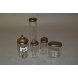 Five various silver mounted cut glass dressing table and condiment bottles
