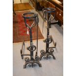 Pair of heavy wrought iron fire dogs with basket tops with maskhead and ring decoration with three