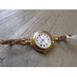 Ladies early 20th Century 18ct gold cased wristwatch with enamel dial and Roman numerals on an