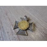 Yellow metal coin marked Krieger Verein, Ringenberg dated 1887 mounted on a metal iron cross dated