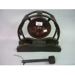 Small Japanese temple gong on a wooden stand with beater