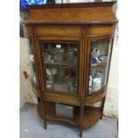 Edwardian mahogany and marquetry inlaid display cabinet, the low shaped back above a central bar