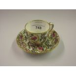 18th Century Sevres porcelain cabinet cup and saucer painted with roses within gilt and green