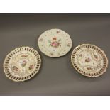Two Copeland porcelain ribbon plates decorated with flowers within gilt borders, together with a