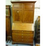 George III satinwood bureau bookcase, the moulded cornice above a pair of panelled doors, the fall