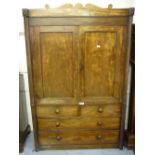 19th Century Irish mahogany linen press, the shaped top above two panelled doors with two short