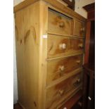 Pine chest of two short and three long drawers, tall pine cupboard and stained pine side cabinet