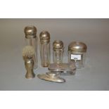 Graduated set of four London silver mounted dressing table bottles, silver mounted shaving brush,