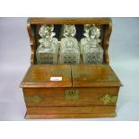 Late 19th Century oak and brass mounted three bottle tantalus Tantalus is not marked Betjeman