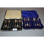 Two cased sets of six silver coffee spoons with tongs