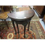 Small George II mahogany half round fold-over tea table with a plain frieze raised on shell carved