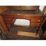 Late Victorian walnut writing table with an inset top above four kneehole drawers raised on turned