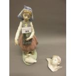 Lladro figure of a girl feeding a duck together with a small Lladro figure of a boy angel