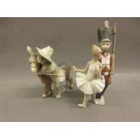 Lladro group of a boy and donkey together with a similar group of a soldier boy and ballerina (at