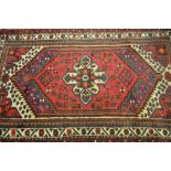 Small Hamadan rug with single gol on a wine red and blue ground with multiple borders, 4ft x 3ft