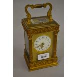 Late 19th Century French gilt brass cased carriage clock, the ornate case decorated with floral