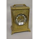 19th Century French brass cased mantel clock, the gilt brass dial with enamelled numerals, with a
