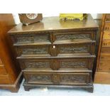 17th Century oak straight front chest of two short and three long drawers with later carved