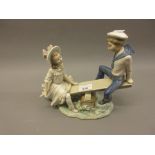 Lladro porcelain group, sailor boy and a girl on a seesaw, 9.5ins high