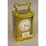 19th Century French gilt brass carriage clock, the enamel dial with Roman numerals and cast