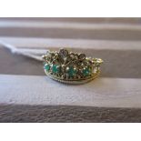 18ct Yellow gold three stone diamond set ring, also set with four emeralds in the form of a crown