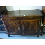 19th Century French oak buffet, the planked moulded top above two drawers with shaped panel doors