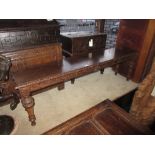 Victorian oak hall bench, the carved top and frieze raised on turned carved tapering supports