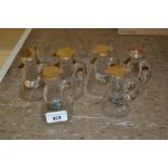 Group of six small silver mounted glass whisky and brandy decanters with labels, two by Goldsmiths