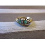18ct Gold ring set two emeralds and four diamonds