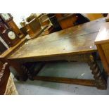 Oak refectory dining table, the plank top above a carved frieze raised on four barley twist supports