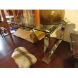 Modern rectangular glass coffee table on chrome end supports, 45ins wide, 22ins deep, 15ins high