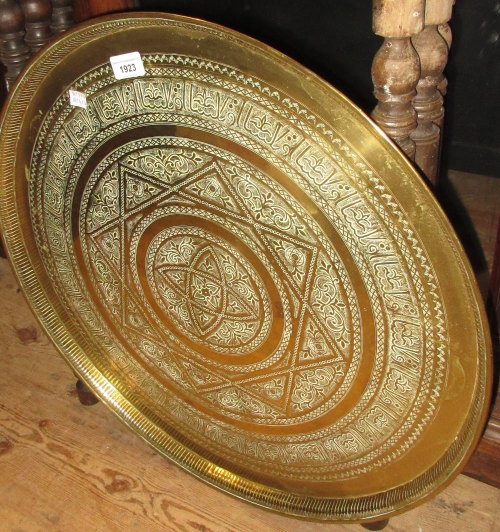 Benares circular brass tray on a folding wooden stand