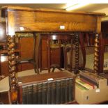 Early 20th Century oak writing table, the triple hinged moulded top enclosing a fitted interior