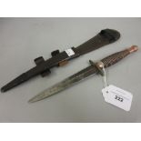 World War II Commando dagger in leather metal tipped sheath (worn handle and blade)