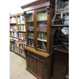 19th Century mahogany bookcase having moulded cornice above two glazed doors enclosing three