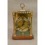 20th Century Thwaites & Reed rolling ball clock, the silvered dial with Roman numerals, 26cms