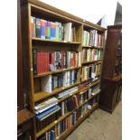 Large light oak open bookcase having adjustable shelves on shaped supports, 78ins high, 76ins
