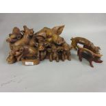Large carved wooden group of pigs together with two other carved wooden figures of pigs The