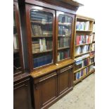 19th Century mahogany bookcase, the moulded top above two arched top glazed doors enclosing