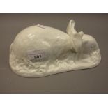 Shelley pottery white glazed jelly mould of a rabbit modelled wearing a bow and eating grass (with