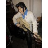 Modern life size painted composition figure of Elvis Presley playing a guitar