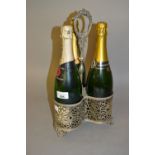 Silver plated three bottle decanter stand with three empty champagne bottles