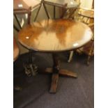 Reproduction oak pedestal table, the circular top above a turned column support