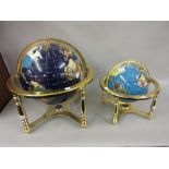 Reproduction globe inset with various minerals on a gilt brass stand together with a similar smaller