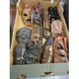 Ten various small 20th Century African carved wooden wall masks together with a pair of similar