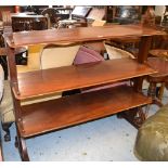 19th Century mahogany three tier buffet raised on rectangular and scroll ends and bun feet