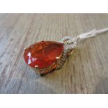 Large tear drop fire opal in a 9ct yellow gold diamond set mount