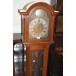 Mid 20th Century mahogany longcase clock with an arched hood above glazed door, raised on bracket