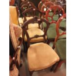 Set of four Victorian walnut dining chairs with upholstered seats, raised on turned front supports