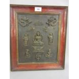 Oriental framed patinated metal plaque decorated with a figure of a Buddha, dragons, sages etc.,